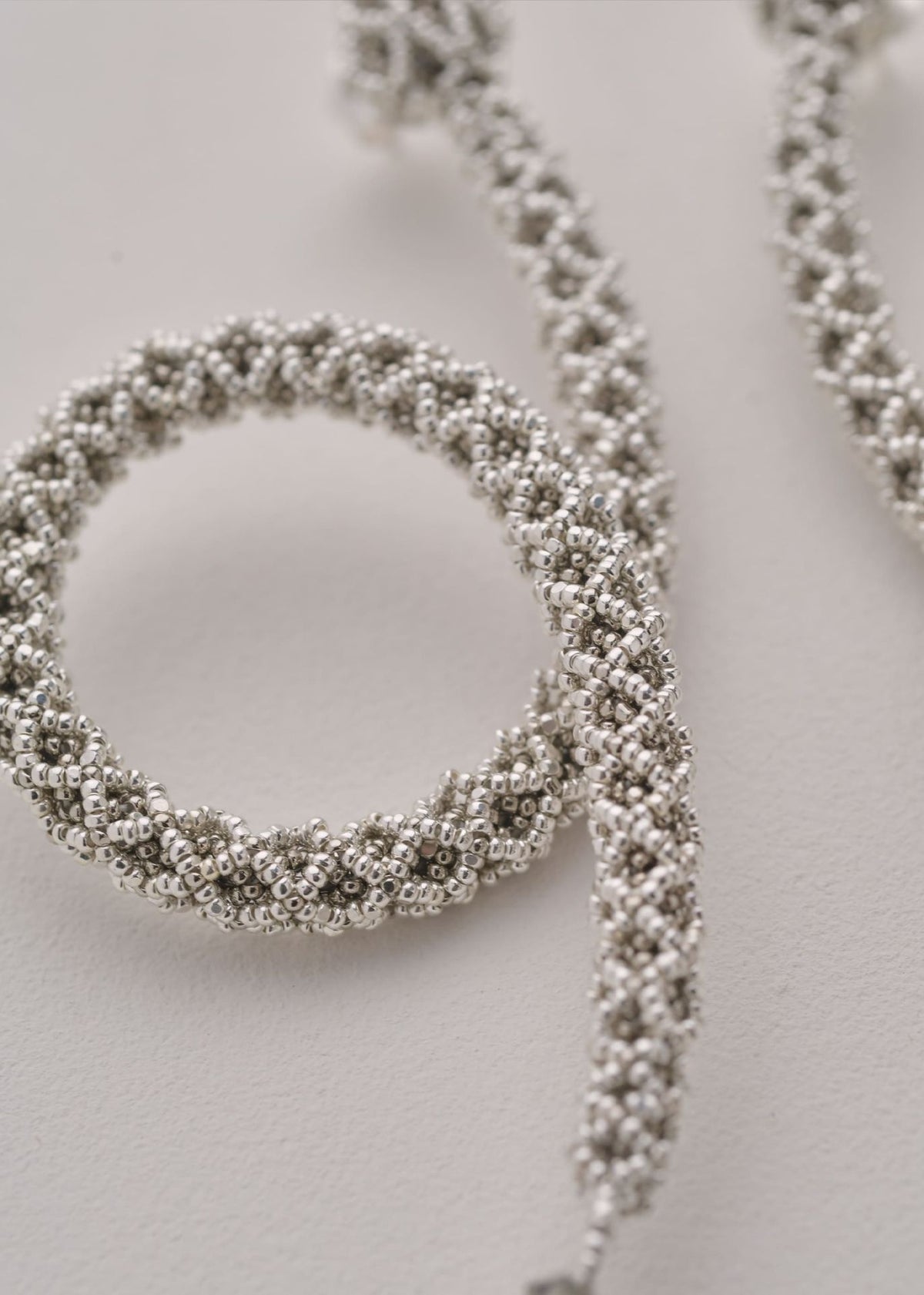 NAWI PLATINUM SILVER SNAKE LOOP EARRINGS