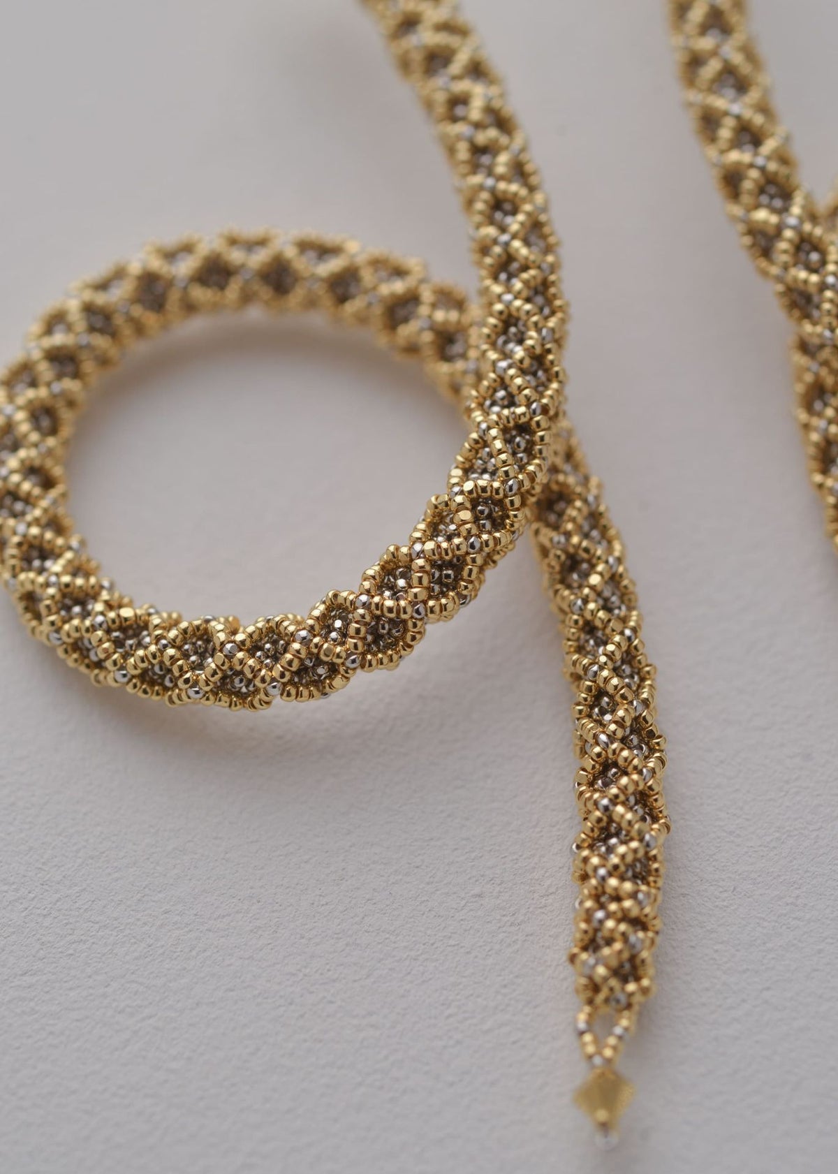 NAWI LOOP SNAKE EARRINGS GOLD PLATINUM